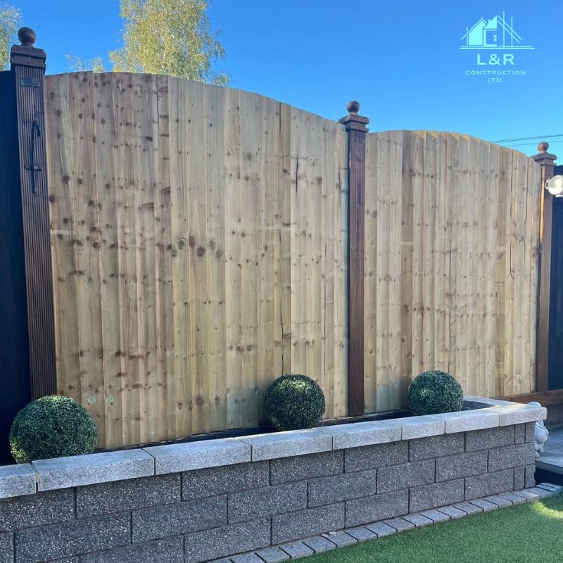 Completed timber garden fencing above a low garden wall