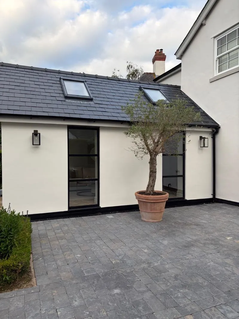 Finished rendered house extension with rooflights and paved patio